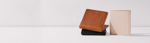 2 leather men's wallets in tan and cream